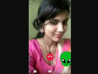 A blonde woman showcases her large breasts in an arousing video chat