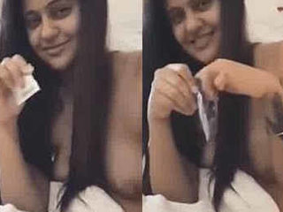 Nicole Bexley, a desi girl, flaunts her big breasts while removing a condom