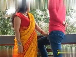 An older woman entices and has sex with a younger man in her neighbor's outdoor space