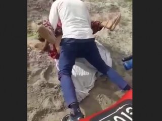 A Rajasthani woman engages in sexual activity with two men in an outdoor setting