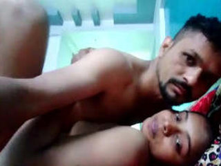 A youthful pair engages in intimate activities within their private quarters