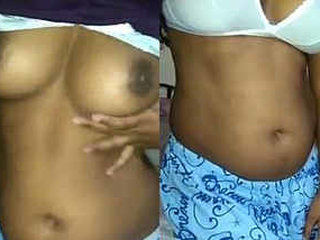 A stunning Indian woman reveals her large breasts and stimulates her moist vagina with her fingers