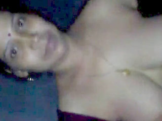 A sultry Indian wife caresses and kisses her lover's breasts