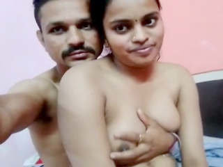 Young attractive woman's tender breasts squeezed forcefully by partner