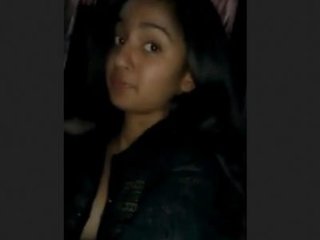 A charming South Asian blonde woman reveals her cleavage by unbuttoning her dress